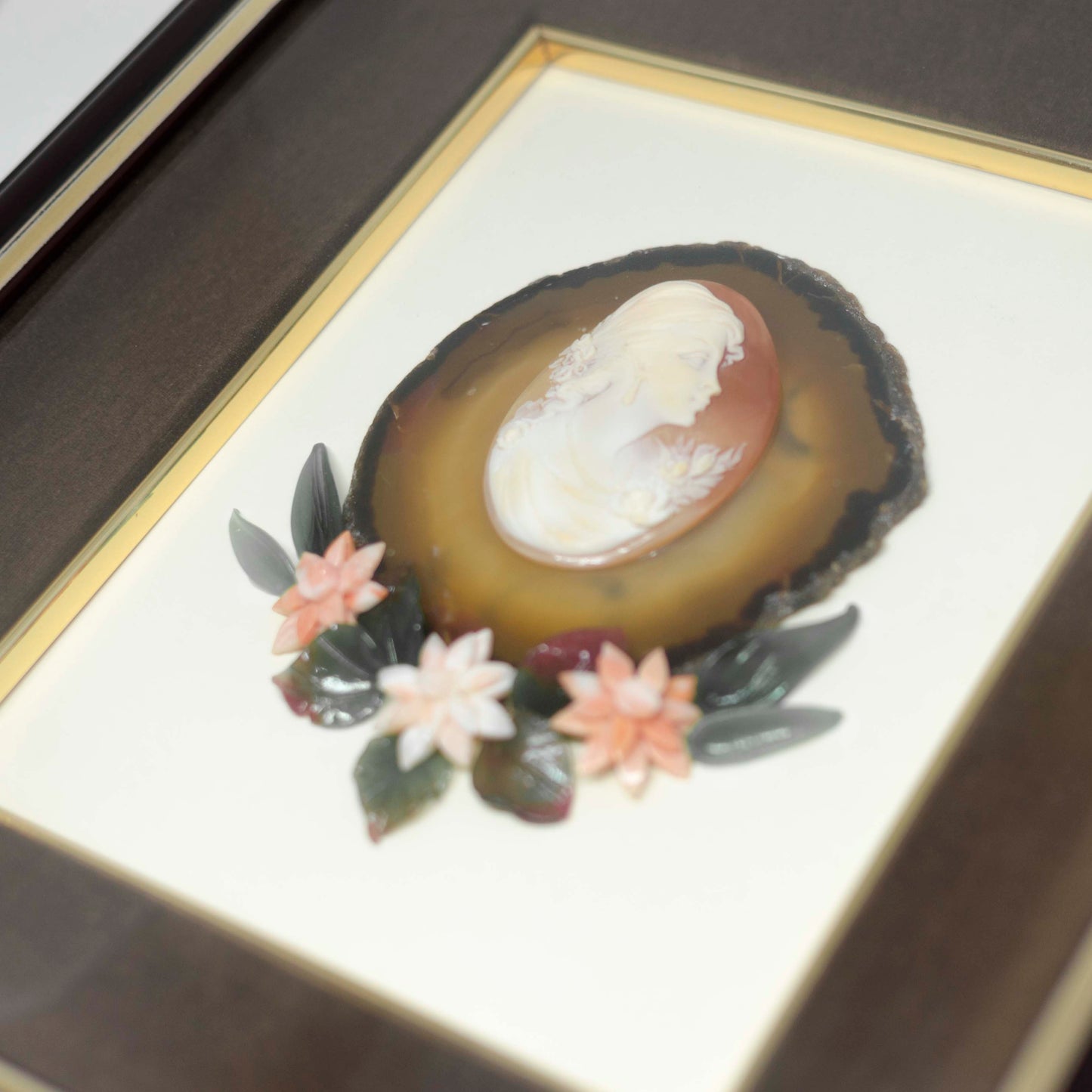 Antique cameo picture on carnelian stone and coral flowers